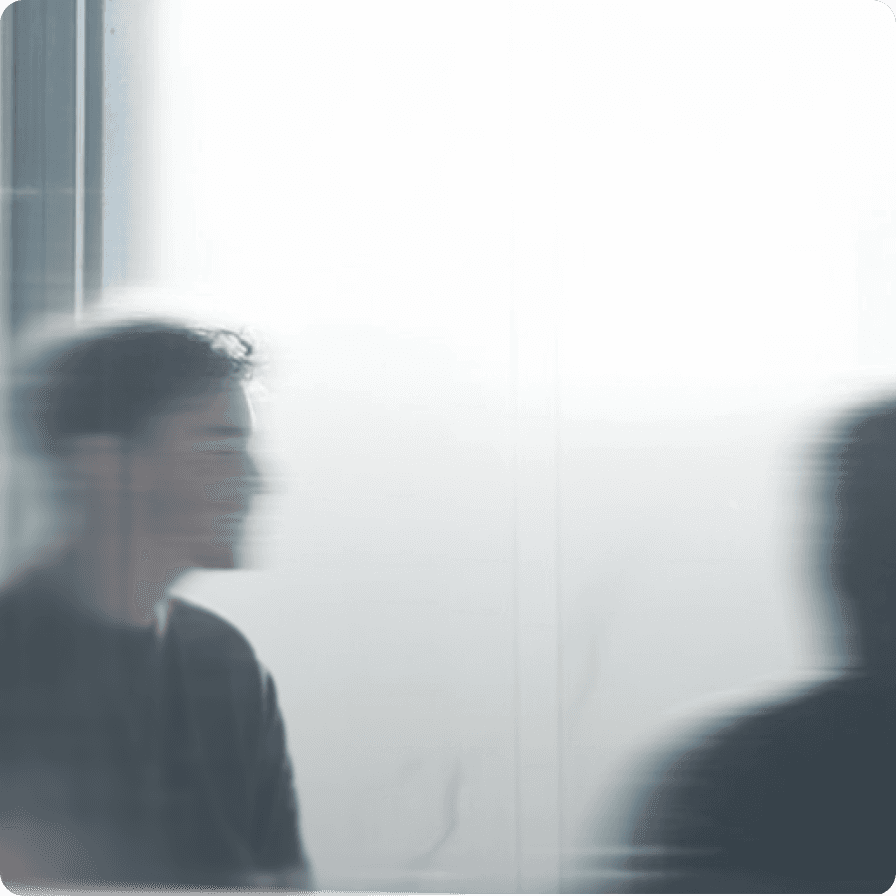 Abstract image of two blurred human figures behind frosted glass, symbolizing data privacy